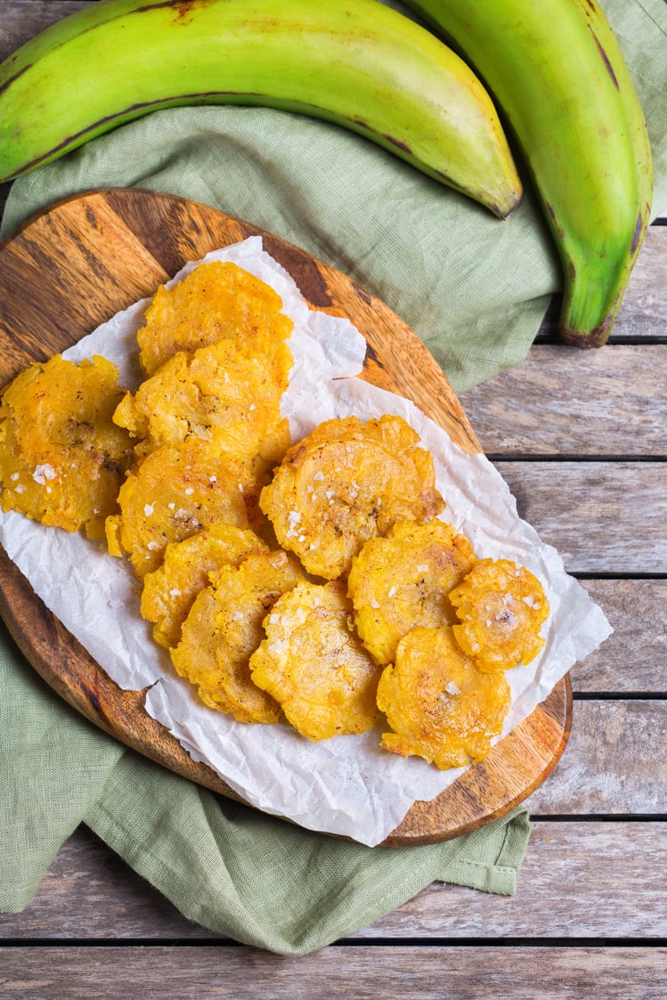 Fried tostones, green plantains, bananas with guacamole sauce